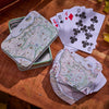 Playing cards with a map design on a wooden surface