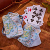 Playing cards with Outer Banks design on a wooden surface