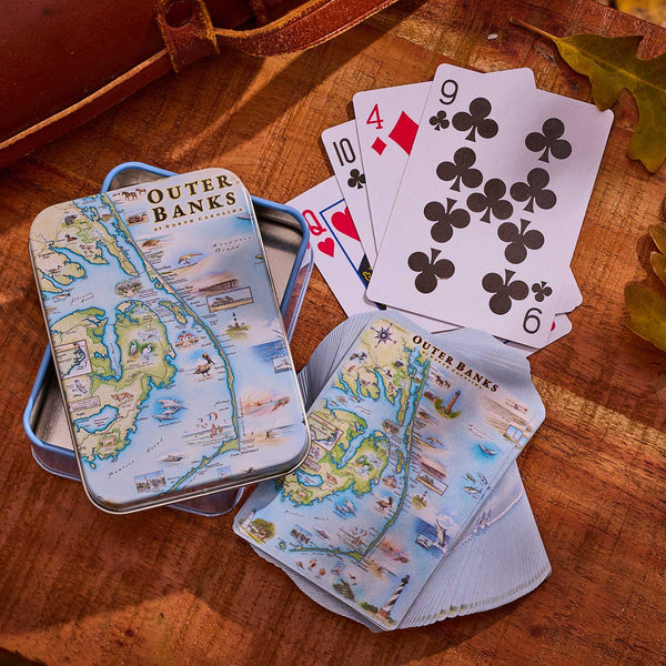 Playing cards with Outer Banks design on a wooden surface