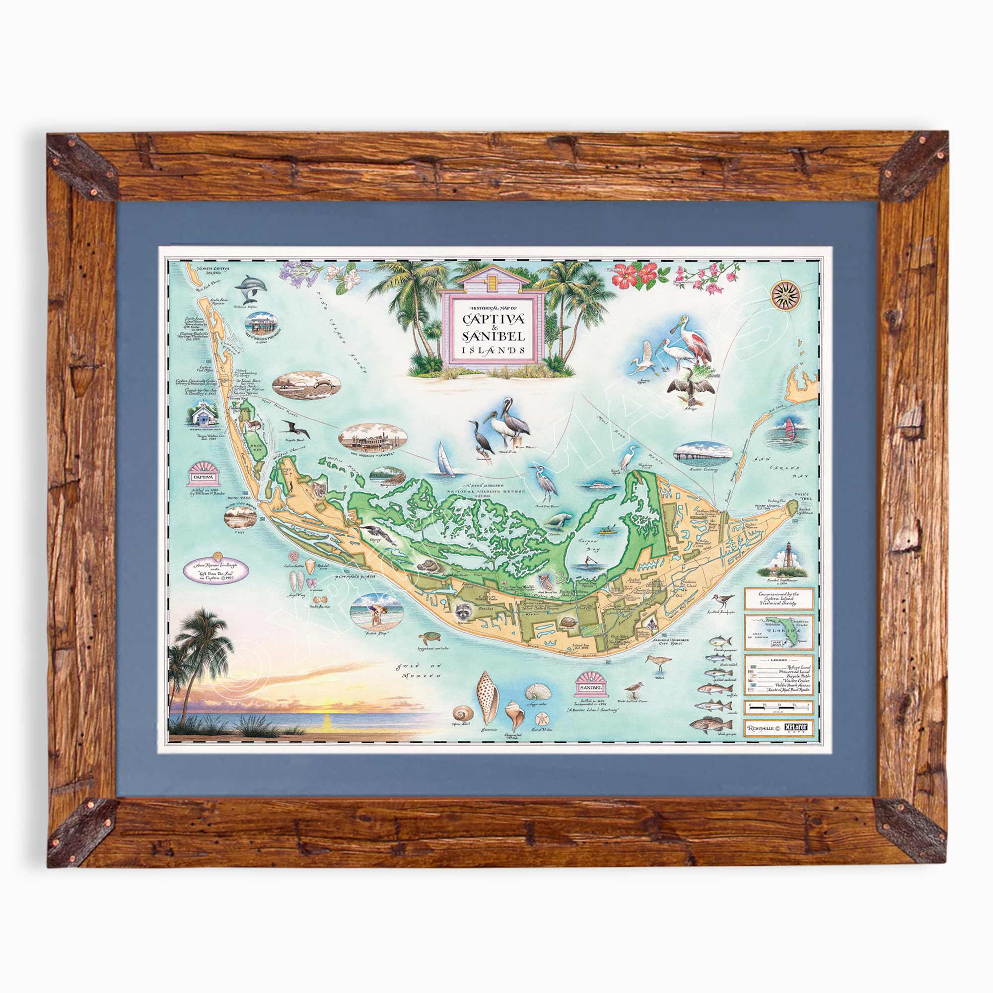 A framed vintage-style map print of Capetia, Nova Scotia, featuring a detailed illustrated island layout with palm trees, boats, landmarks, and a sunset along the coastline. The print is mounted with a blue mat inside a rustic brown wooden frame, shown against a plain white background.
