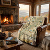 Cozy living room with a fireplace, map blanket, and scenic window view.