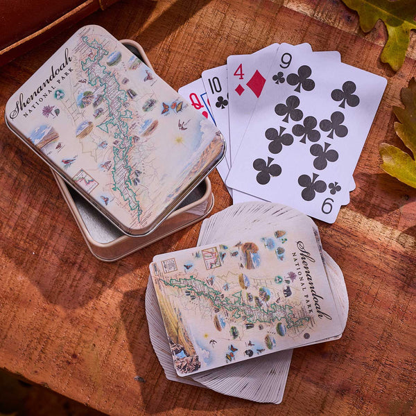 Playing cards with map design on a wooden surface
