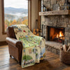 Cozy living room with a fireplace, guitar, and scenic blanket draped over a chair.