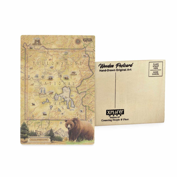 Yellowstone National Park Map wooden postcard in earth tone colors featuring hand-drawn illustrations of Old Faithful, Grand Prismatic Spring, and native wildlife including bison and grizzly bears.