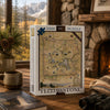 A 1000-piece jigsaw puzzle box featuring a vintage map of Yellowstone National Park, displayed on a rustic wooden table in a cozy room setting with a fireplace, binoculars, and a coffee mug.