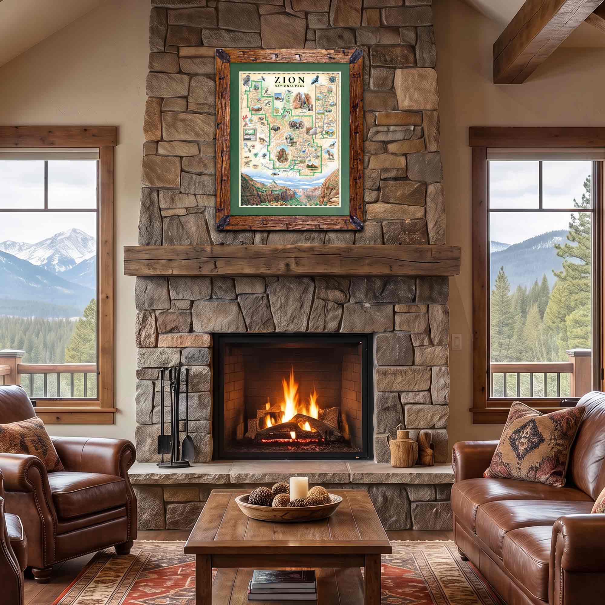 A framed Zion city map print hangs above a stone fireplace in a rustic living room with leather sofas, a coffee table, and mountain views through the windows.
