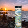 Canada's 1000 Islands Map -16 oz Travel Drinkware sitting on rocks by water during sunset.