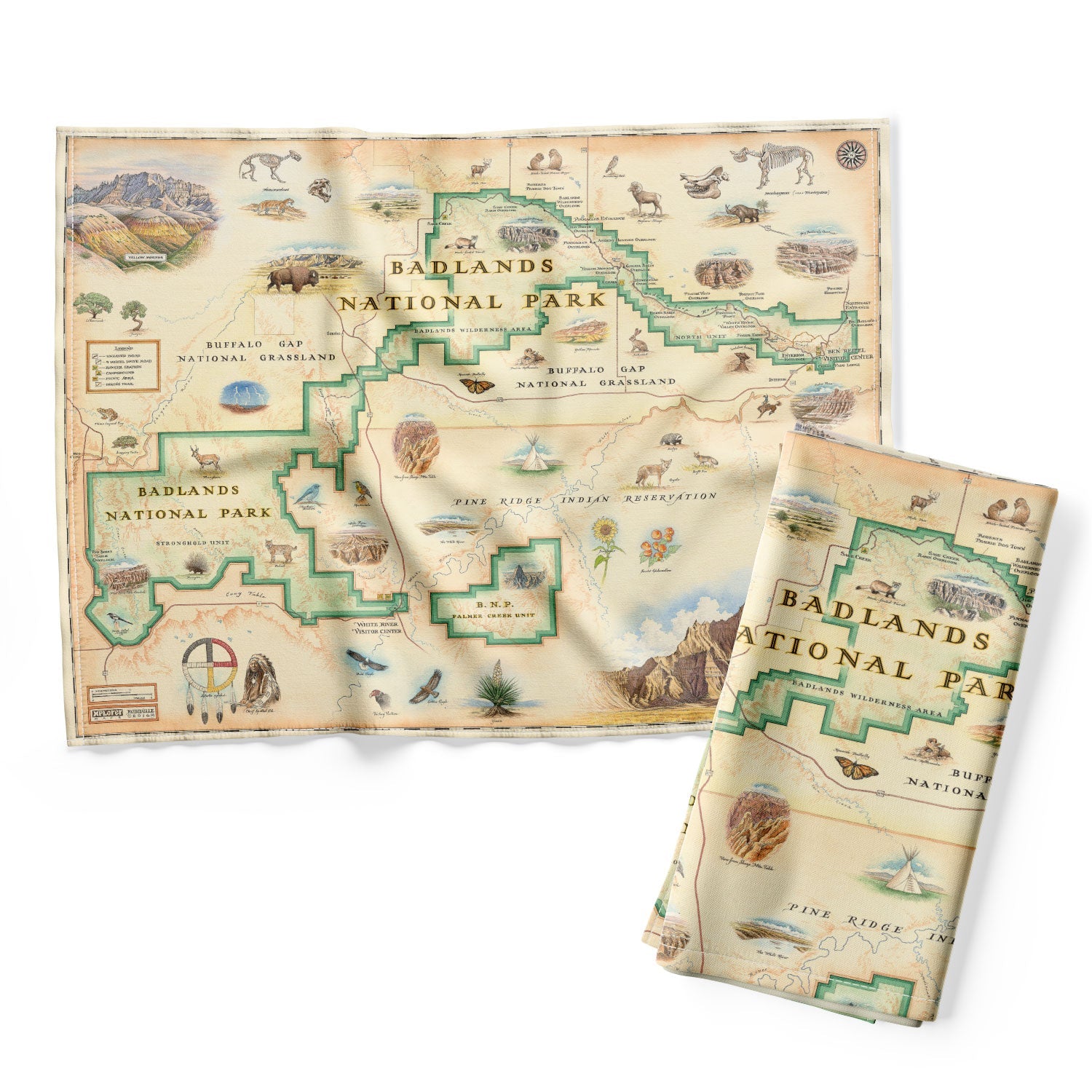 Badlands National Park Map kitchen dishtowel in earth-tone colors. It features Buffalo Gap Grasslands, Vulture Peak, and Yellow Mounds Overlook. Flora and fauna of Jasper Tree, Yucca plant, deer, dinosaurs, birds, and fox.