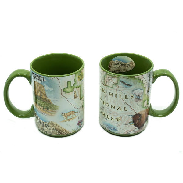 Black Hills National Forest Map ceramic mug. The front of the cup shows Mount Rushmore. The back features a mountain lion and Devils Tower - 16 oz, Green