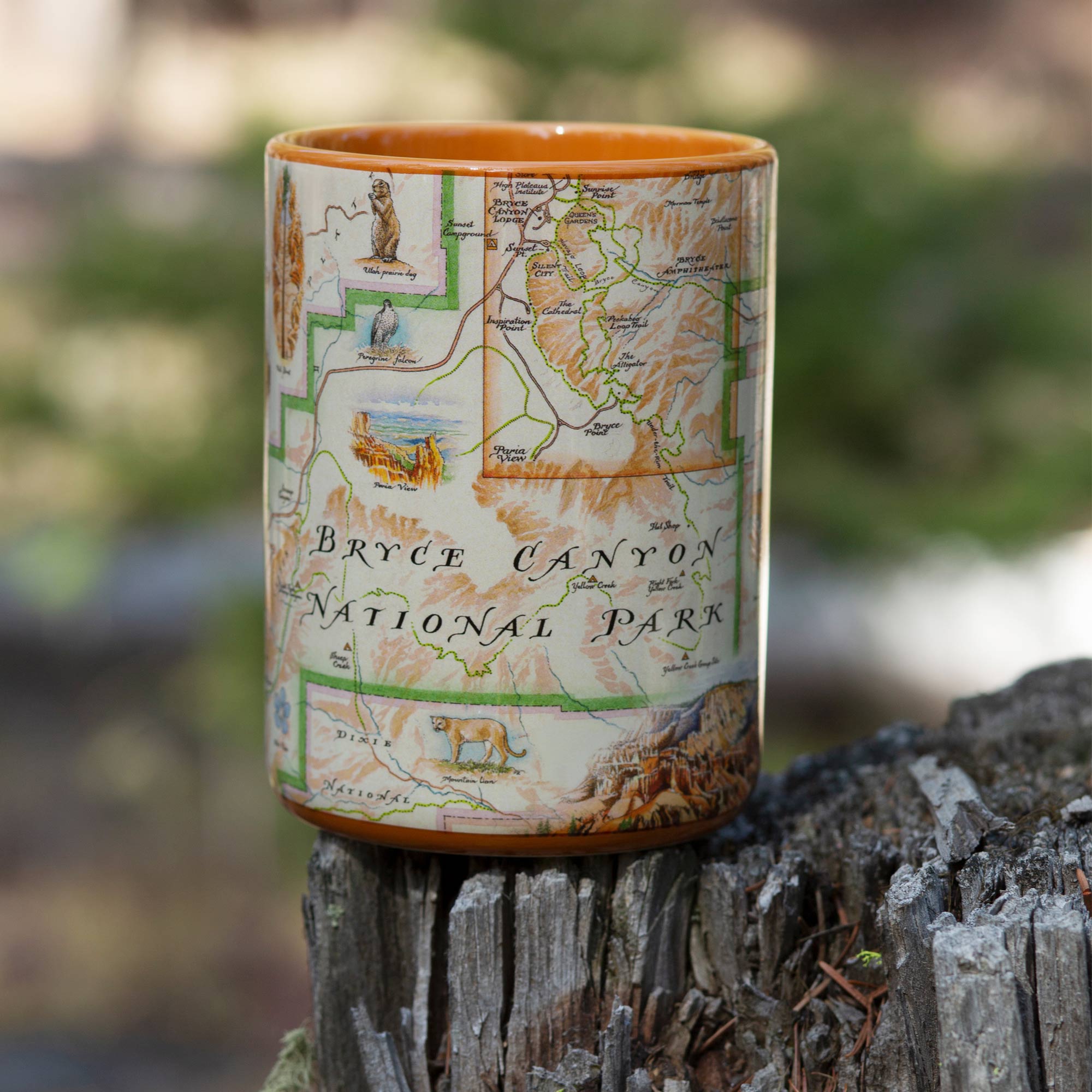 Bryce Canyon orange mug sitting on a tree stump. Bryce Canyon orange mug sitting on a tree stump. The cup features mountain lion, Thor’s Hammer and monstrous hoodoos.