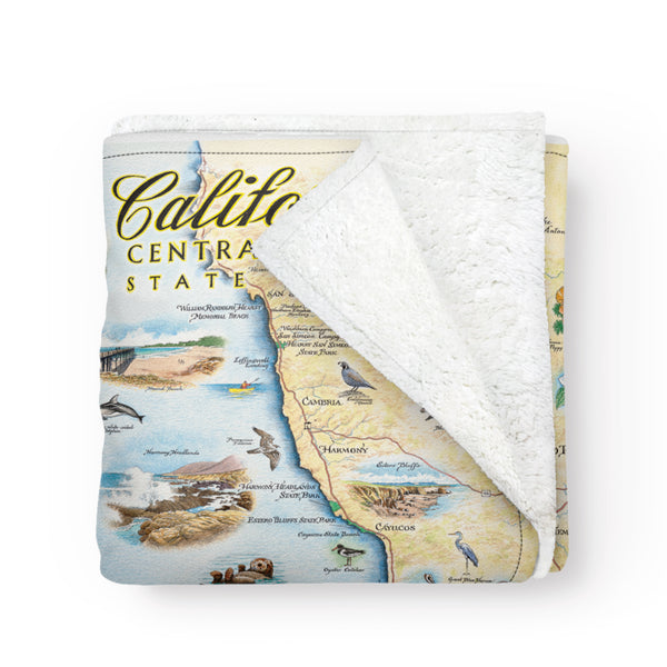 California Central Coast State Map Fleece Blanket in earth tones. Featuring black bear, ocean, butterfly, seal, sharks, San Luis Obispo, and San Simeon. Measures 58"x50."