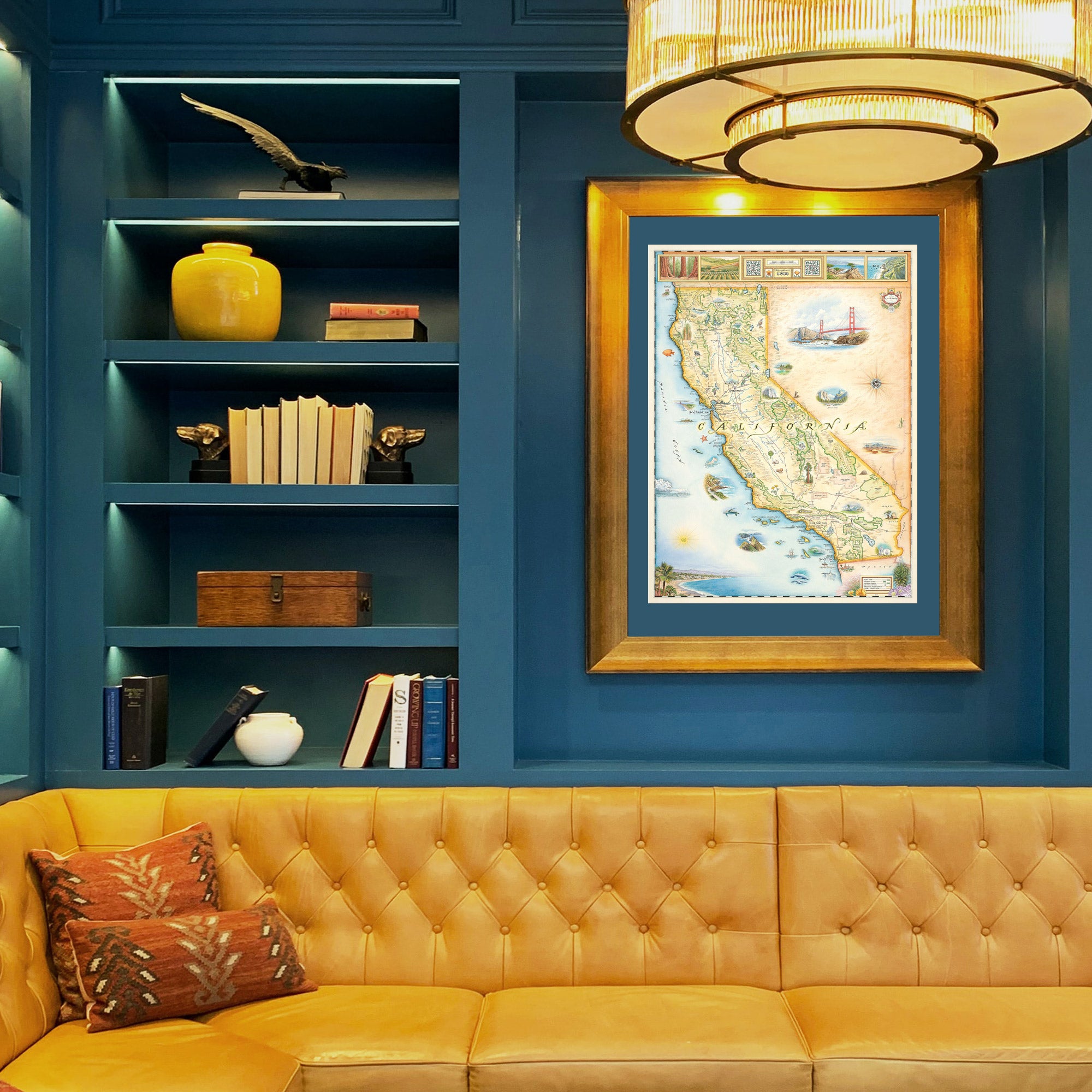 California hand-drawn map framed with blue mat hanging over a gold couch.
