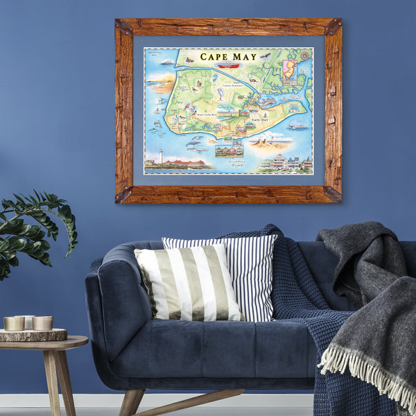 New Jersey's Cape May map was framed in wood and hand-scraped in Montana. The framed map is hanging on a wall above a blue couch. 