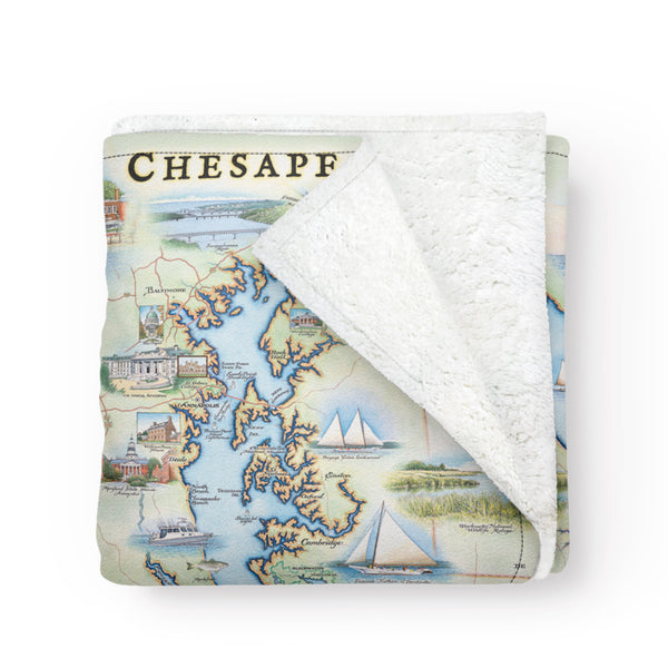 Chesapeake Bay Map fleece blanket in earth tone colors blue and green. The map features blue crab and sail boats. Measures 58"x50."