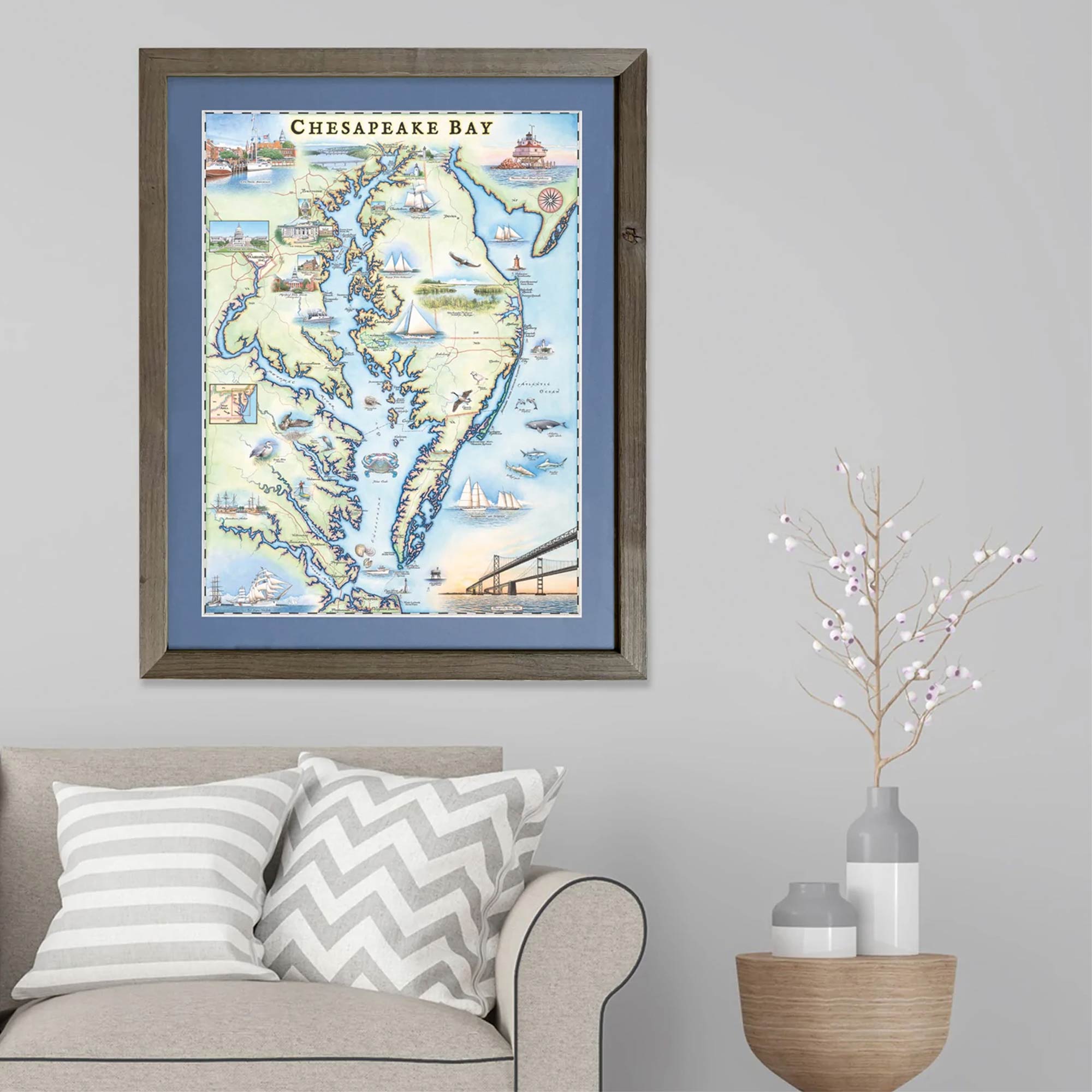 Chesapeake Bay map un a grey frame with blue mat hanging over a couch.