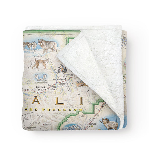 A folded blanket with a map of Denali National Park on it. Artist made!