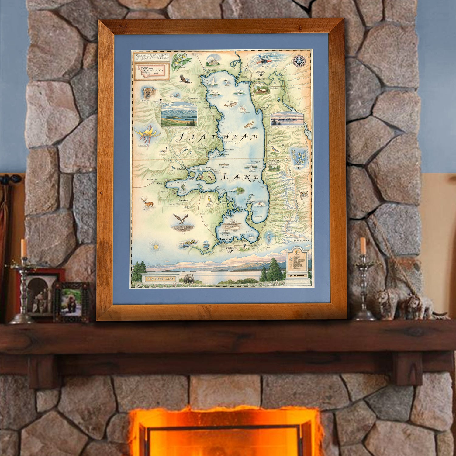 Flathead Lake hand-drawn story-map in a montana larch. The picture is sitting on a mantel ledge on a fireplace. 