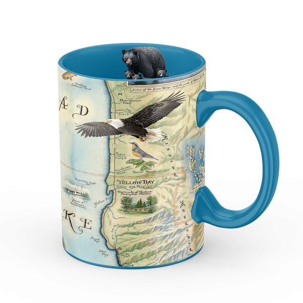 Montana's Flathead Lake ceramic coffee mug featuring bald eagle, black bear and cubs, birds, and flowers. Blue - 16 oz