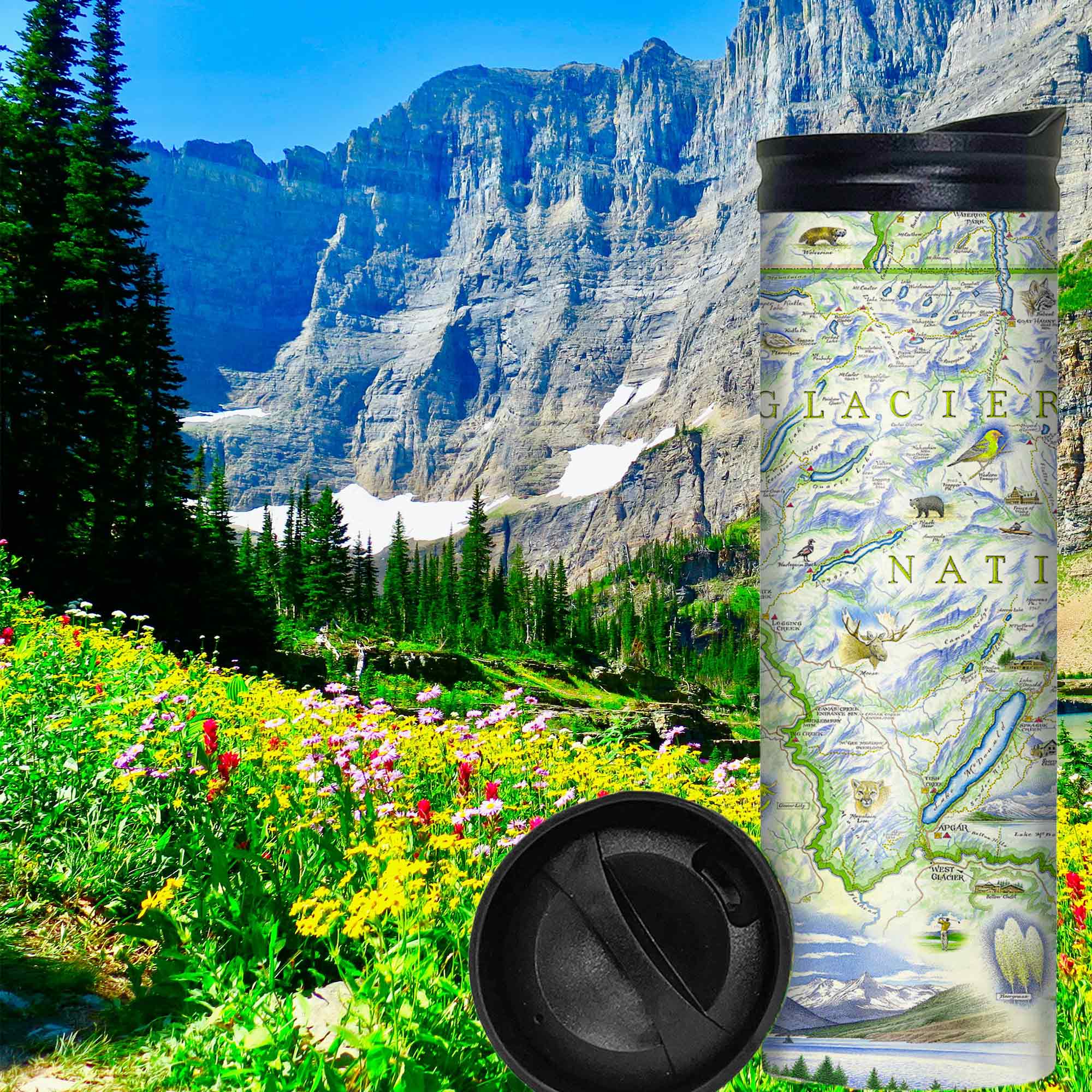 Glacier National Park Map travel drinkware is sitting in a grassy field with wild flowers in Glacier. The backgoruns has a snoe capped mountain. The map features places in the park such as Logan Pass, Lake McDonald Lodge, Many Glacier Lodge, Two Medicine, Glacier Park Lodge, and the Going-to-the-sun Road. Flora and fauna include grizzly bears, elk, moose, mountain goats, and mountain lions.