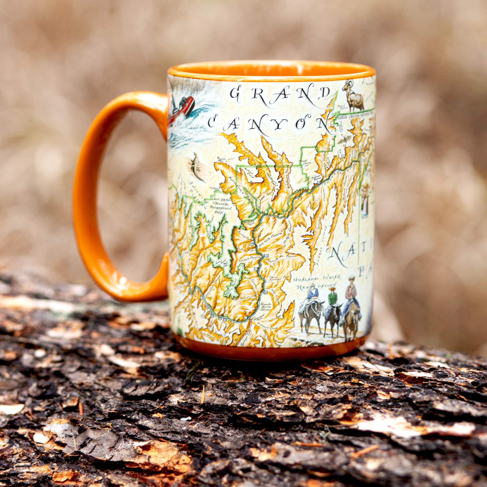 Grand Canyon National Park Map Coffee Mug sitting on a log in the forest. Burnt Orange - 16oz