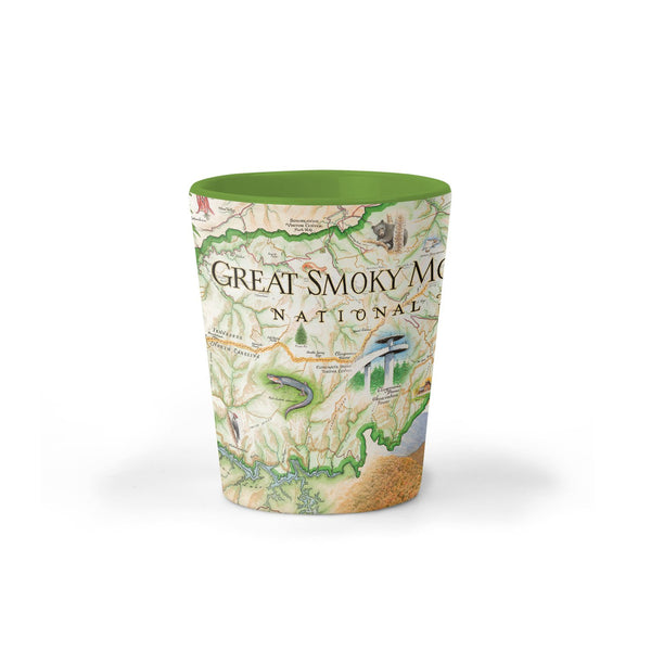 Great Smoky Mountains National Park Map Ceramic shot glass by Xplorer Maps. The map depicts the entire National Park on the border of North Carolina and Tennessee. It features illustrations of a salamander, woodpecker, Clingman's Dome, Sugarland's Visitor Center, and Oconoluftee Visitor Center. 