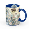Alaska's Inside Passage 16 oz ceramic mug - Blue. The coffee cup features bear, wolf, First Nation Totem pole, and pacific ocean.