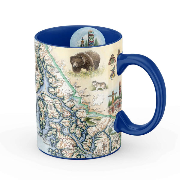 Alaska's Inside Passage 16 oz ceramic mug - Blue. The coffee cup features bear, wolf, First Nation Totem pole, and pacific ocean.