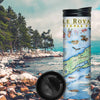 Isle Royale National Park travel mug on a rocky beach near water and pine trees. The map features flora and fauna such wolf, moose, Pink Lady Slippers, and Thimbleberries. Other illustrations include Lookout Louise, Rock of Ages Lighthouse, and the Rocky Harbor Lodge. 