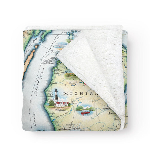 Folded blanket with a map of Michigan on it. Soft and cozy fleece blanket. Artistic map blanket. Measures 58"x50."