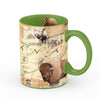 Green 16 oz Montana state map ceramic coffee mug. The cup features bison, Grizzly bears, Fort Peck, cowboy, First Nation people, Crow lands, Pronghorn, and trout.