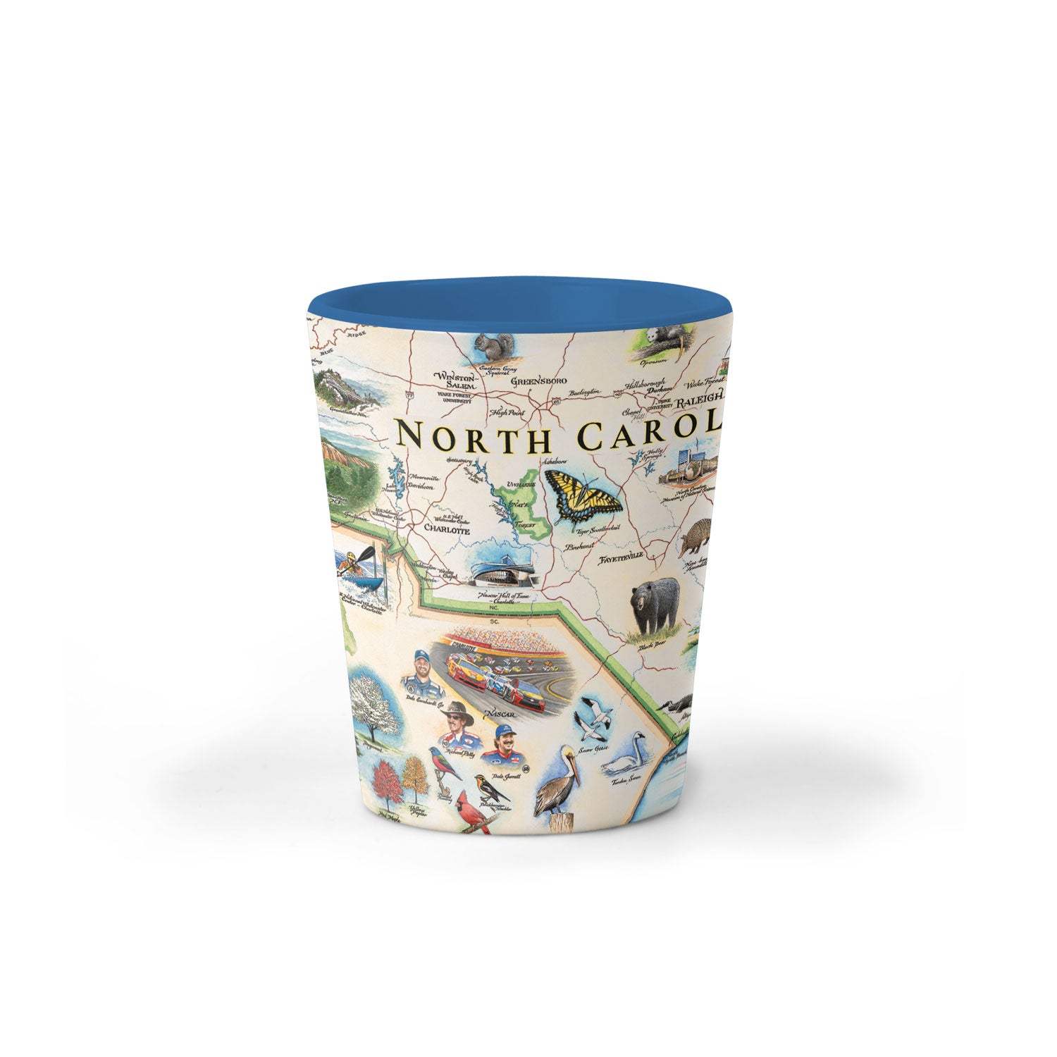 North Carolina Map Ceramic shot glass by Xplorer Maps.  The map features Dry Falls in the Nantahala National Forest, the Outer Banks, a Nascar Hall of Fame, and the USS North Carolina on the coast.