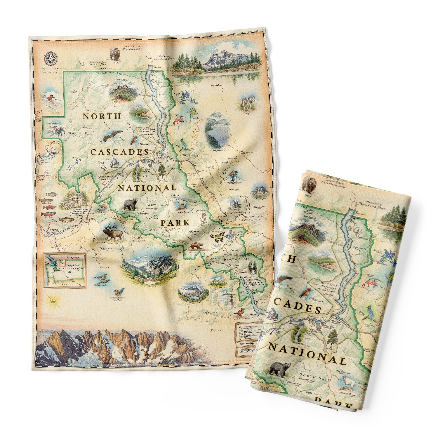 The North Cascades 100% cotton flour-sack dishtowels in earth tones of green and blue. Featuring illustrations of black bear, elk, wolverine, glacier lily, and huckleberries. Other illustrations include Pickett Range, Cascade Pass, and Lake Chelan Recreation area.