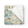 Folded fleece blanket with an Oregon state map. Hand-drawn and full-color blanket. Cozy and soft.