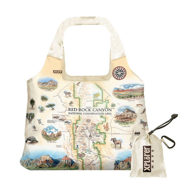 Red Rock Canyon National Conservation Area Map Pouch Tote Bags by Xplorer Maps. The map features illustrations of places such as Mt. Willson, Rainbow Mountain, Bridge Mountain, and Spring Mountain Ranch. Flora and fauna include a red tail hawk, desert Bighorn, Globemallow, Joshua tree, and Prickly pear cactus.