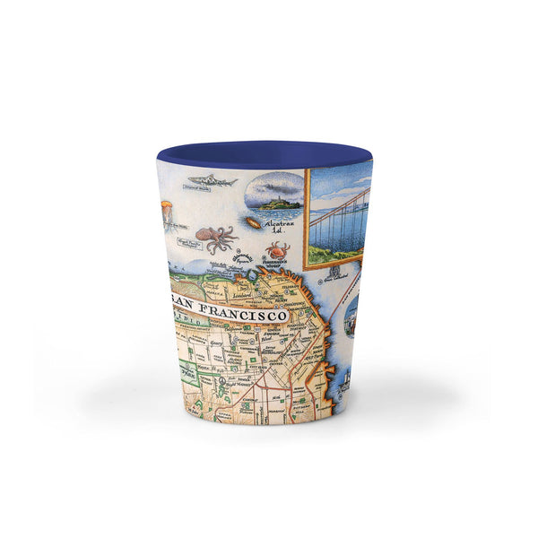San Francisco Bay Map Ceramic shot glass by Xplorer Maps. The map features illustrations of places such as Candlestick Park, Fisherman's Wharf, Transamerica Pyramid, and Alcatraz Island. Flora and fauna include octopus, crab, palm trees, and a dahlia. 