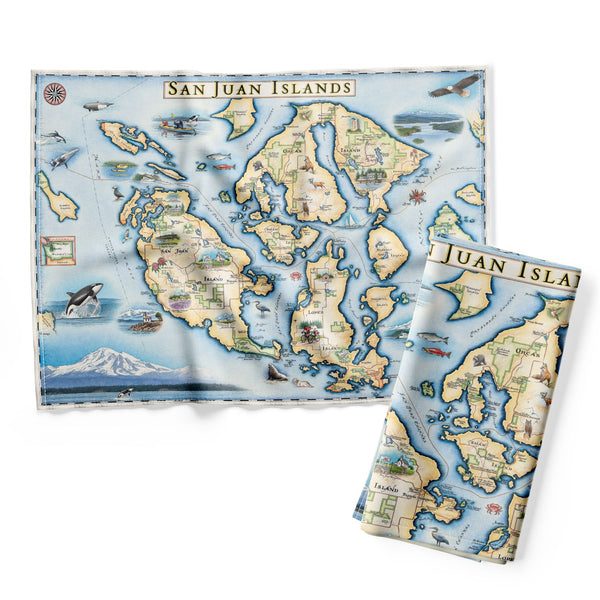 The San Juan Islands Kitchen Dishwashing Towel in earth tones of blue and green features illustrations of places such as San Juan Vineyard, Turtleback Mountain Reserve, Liv Winery, and Roche Harbor. Include Orca Whale, Puffin, Herron, camas flower, and rhododendron.