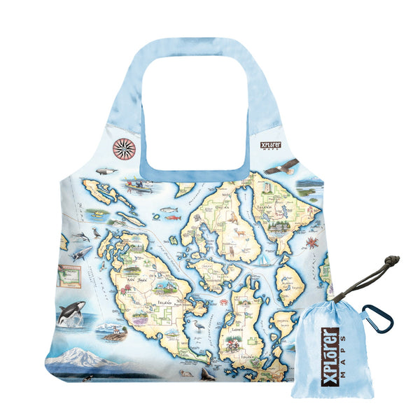San Juan Islands Map Pouch Tote Bags by Xplorer Maps. The map features illustrations of places such as San Juan Vineyard, Turtleback Mountain Reserve, Liv Winery, and Roche Harbor. Flora and fauna include Orca Whale, Puffin, Herron, camas flower, and rhododendron.