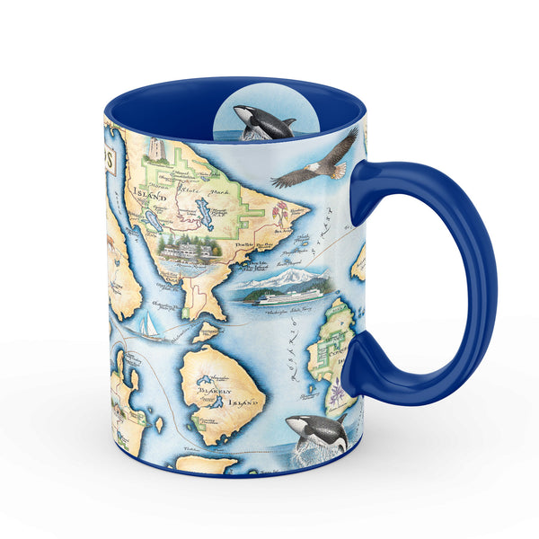 San Juan Islands Map Ceramic Mug. The map features illustrations of places such as San Juan Vineyard, Turtleback Mountain Reserve, Liv Winery, and Roche Harbor. Flora and fauna include Orca Whale, Puffin, Herron, camas flower, and rhododendron.