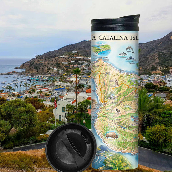 Santa Catalina Island Travel thermos mug with city and mountains in the background. The map features illustrations of places such as Wrigley Memorial, El Rancho Escondido, and Avalon Bay. Flora and fauna include Bison, Catalina Island Fox, Catalina Orange Lip butterfly, Channel Islands tree poppy, and Island oak. 