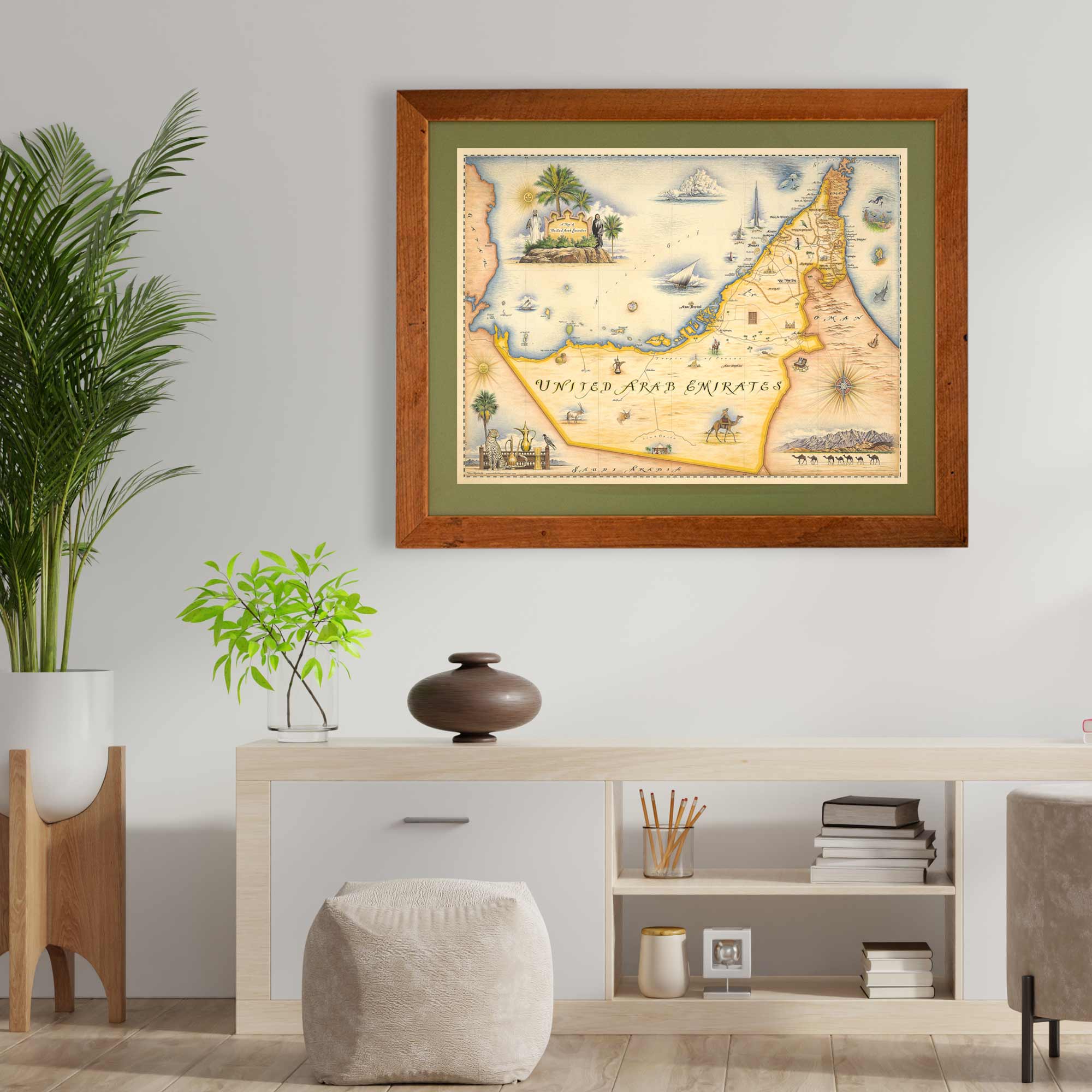 The United Arab Emirates framed hanging on a wall in the living room. There is a plant next to the map print. 