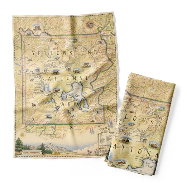 Yellowstone National Park Kitchen Dishwashing Towel in earth tones beige and yellow features illustrations of places such as Yellowstone Lake, Old Faithful, and Roosevelt tower. Flora and fauna include a mountain lion, grizzly bear, fireweed, and lupine. 