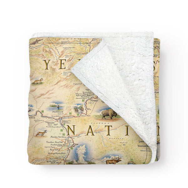 Folded fleece blanket with a map of Yellowstone National Park on it.