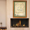 Xplorer Map of Yellowstone National Park hangs framed on a wall above a fireplace.