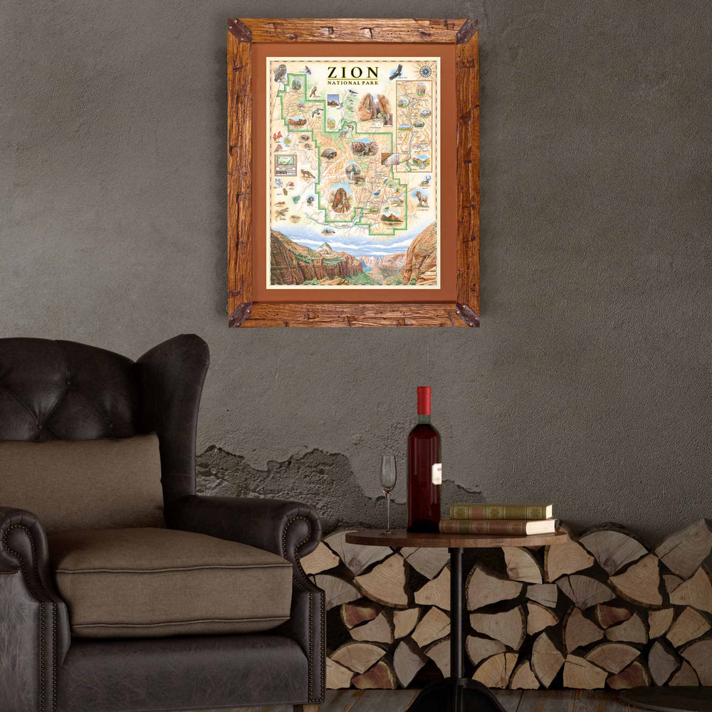 Zion National Park hand-drawn map hanging above a wood pile above a leather brown chair. 
