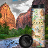 "Zion National Park Map 16 oz Travel Drinkware. In the background is the iconic Angels Landing.  The map features illustrations of Angels Landing, Weeping Rock, The Narrows, and Kolob Canyon. Flora and fauna include Mojave desert tortoise, western columbine, and desert marigold. "